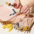 Model Arranging Flowers in the Yellow and Blue Dried Flowers Letterbox Gift