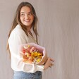 Model Holding Yellow and Pink Dried Flower Bouquet