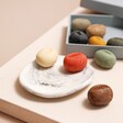 Hana Blossom Wellness Pebble Soaps Placed on Porcelain Dish on Neutral Background