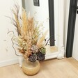Large Round Hand-Painted Vase in Grey in Lifestyle shot with dried flowers inside next to mirror