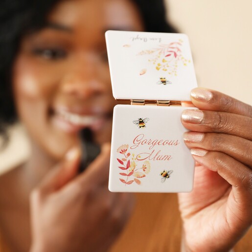 Model Holding Gorgeous Mum Compact Mirror on Neutral Background