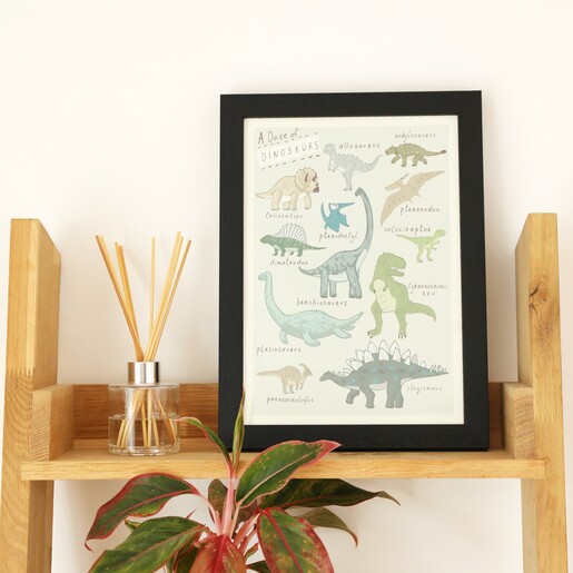 Lifestyle shot of Dose of Dinosaurs A4 Framed Print on shelf with reed diffuser