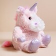 Warmies 9” Junior Sparkly Pink Unicorn Soft Toy sitting on neutral surface