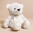 Warmies Microwaveable Marshmallow Bear Soft Toy sitting on neutral surface