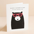 The Art File Coolest Dad Bear Father's Day Card standing against beige coloured backdrop