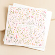 The Art File Floral Sympathy Greetings Card on top of envelope against neutral backdrop