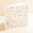 The Art File Floral Sympathy Greetings Card standing up against beige coloured background