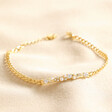 Crystal and Pearl Bar Bracelet in Gold on top of beige coloured fabric
