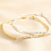 Crystal and Pearl Bar Bracelets in Silver and Gold Stacked on Beige Fabric
