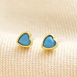 Blue Stone Heart Stud Earrings in Gold on Beige Fabric