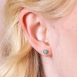 Close Up of Blue Stone Heart Stud Earrings in Gold on Model
