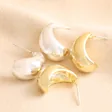 Chunky Teardrop Half Hoop Earrings in Gold with silver version on beige fabric