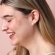 Green Teardrop Crystal Huggie Hoop Earrings in Gold on Model