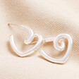 Large Scribble Heart Hoop Earrings in Silver on Beige Fabric