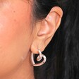 Close Up of Large Scribble Heart Hoop Earrings in Silver on Model