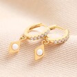 Opal Diamond Huggie Hoop Earrings in Gold on Beige Fabric