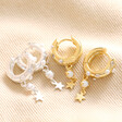 Pearl and Crystal Star Charm Huggie Hoop Earrings in Silver with gold version on neutral background