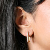 Close Up of Rectangular Crystal Huggie Hoop Earrings in Gold on Model