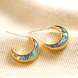 Shell Crescent Moon Hoop Earrings in Gold on top of beige coloured fabric