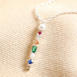 Close up of pendant on Colourful Gemstone Bar Pendant Necklace in Silver on top of beige fabric