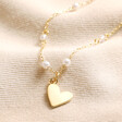 Beaded Pearl Heart Pendant Necklace in Gold on Beige Fabric