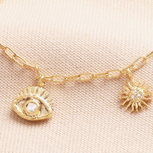 close up of Hamsa Hand Charm Necklace in Gold featuring the evil eye charm and the sun