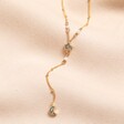 Shell Moon and Star Lariat Necklace in Gold on Beige Fabric