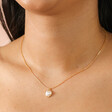 Close Up of Pearl Heart Pendant Necklace in Gold on Model