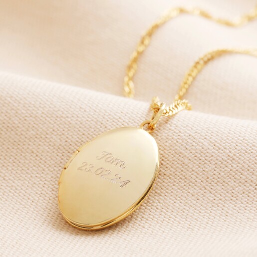 Gold Locket Personalised Oval Locket Necklace in gold against neutral coloured material