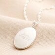 Personalised Oval Locket Necklace in silver against neutral coloured fabric