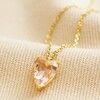 Pink Faceted Crystal Heart Pendant Necklace in Gold on Beige Fabric