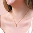Close Up of Small Halo Clasp Pendant Necklace in Gold on Model