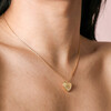 Close up of Sunbeam Heart Pendant Necklace in Gold on model