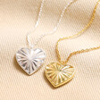 Close up of Sunbeam Heart Pendant Necklace in Silver with gold version on beige backdrop
