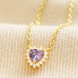 Tiny Purple Crystal Heart Pendant Necklace in Gold on Beige Fabric