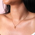 Close Up of Yellow Faceted Crystal Heart Pendant Necklace in Gold on Model