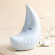 Smiling Crescent Moon LED Night Light on Beige Surface