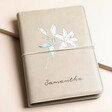 Personalised Birth Flower Vegan Leather Refillable Notebook in grey with flower and Samantha personalisation against beige backdrop