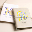 Personalised Bold Initial Vegan Leather Refillable Notebooks in grey and pink with K and H personalisations on beige backdrop