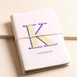 Personalised Bold Initial Vegan Leather Refillable Notebook with K personalisation on top of beige backdrop