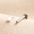 Tish Lyon Solid White Gold Tiny Star Helix Earring with attachment outside of labret on top of neutral coloured material