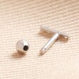 Tish Lyon Solid White Gold Crystal Microbar Barbell undone showing barbell fastening on beige coloured material