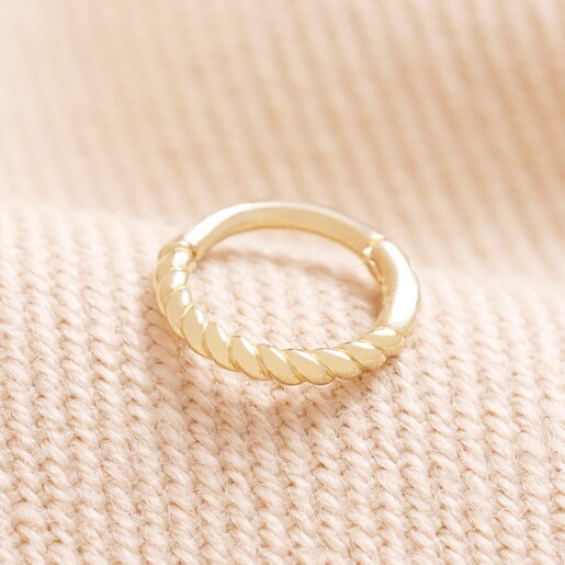 Tish Lyon Solid Gold Rope Tiny Hoop Earring on top of beige coloured fabric