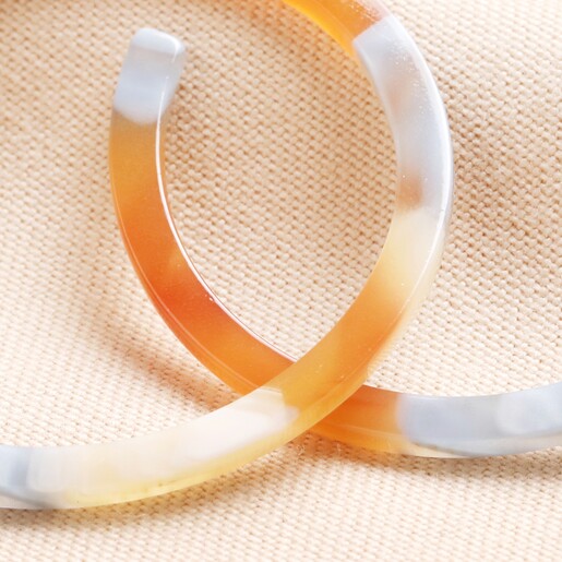 Close Up of Big Metal London Large Resin Hoop Earrings in Orange