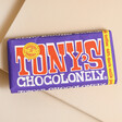 Tony's Chocolonely Dark Milk Chocolate Pretzel and Toffee Bar on Beige Surface