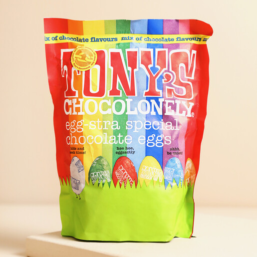 Tony's Chocolonely Egg-stra Special Mix of Chocolate Mini Eggs In Bag on Beige Surface 