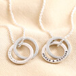 Personalised Sterling Silver Interlocking Crystal Rings Necklaces against beige coloured backdrop