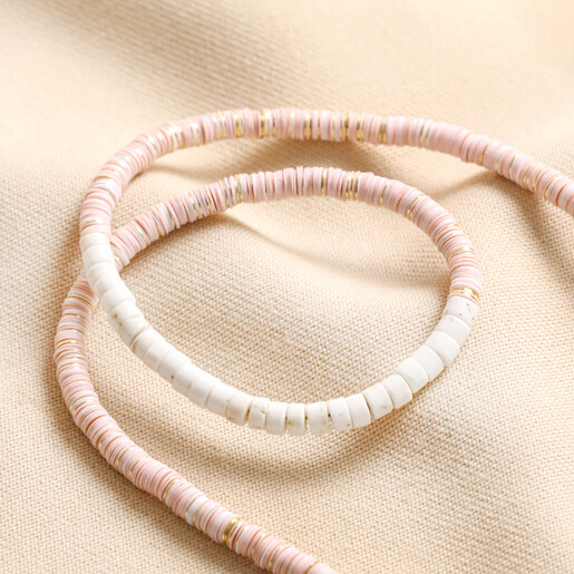 Pink and White Semi-Precious Heishi Beaded Necklace Pink and White Semi-Precious Heishi Beaded Necklace arranged on top of beige coloured fabric