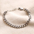 Men's Sterling Silver Curb Chain Bracelet on top of neutral coloured fabric