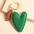 Caroline Gardner Vegan Leather Heart Keyring Showing Green Side on Beige Platform
